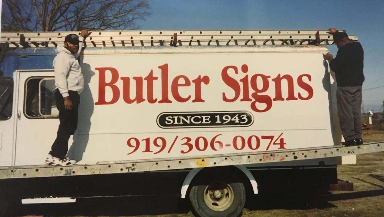 The Butler Signs delivery truck with hand-painted lettering and 'Since 1943'